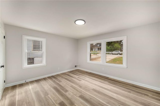 1282 Westridge Rd SW, Atlanta, GA 30311 - unfurnished room with visible vents, light wood-type flooring, and baseboards