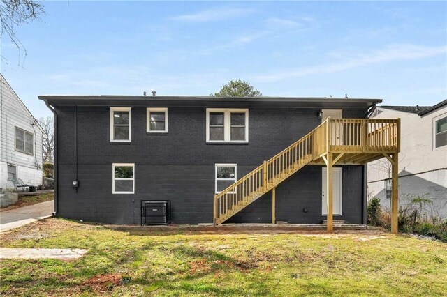 1282 Westridge Rd SW, Atlanta, GA 30311 - rear view of property featuring stairway, a lawn, and a deck