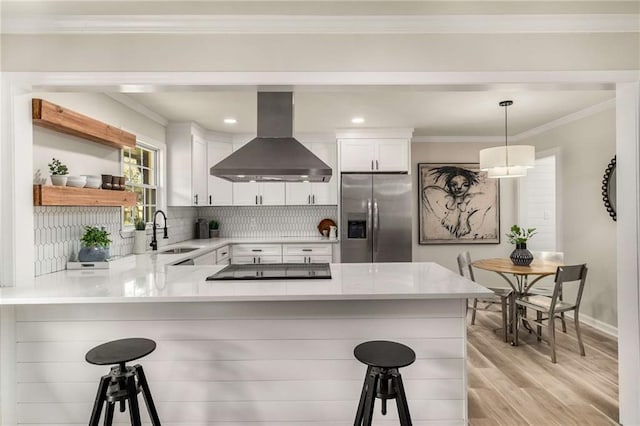 1282 Westridge Rd SW, Atlanta, GA 30311 - kitchen with a sink, a kitchen breakfast bar, stainless steel fridge, island range hood, and crown molding