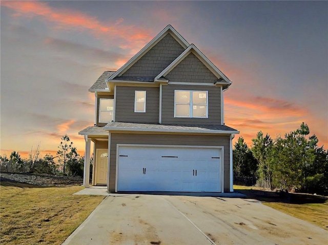 view of front facade with a garage and a yard