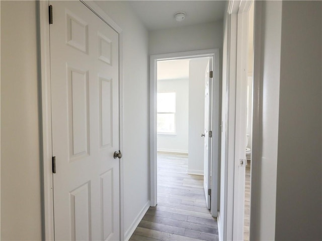 corridor with light hardwood / wood-style floors