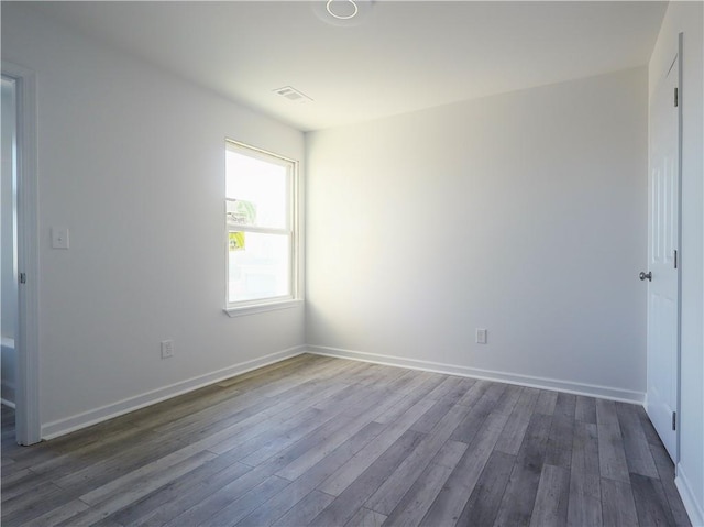 spare room with dark hardwood / wood-style floors