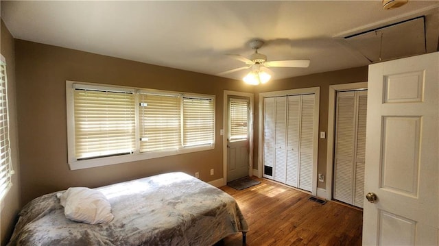 1171 Goodwin Rd NE, Atlanta, GA 30324 - bedroom featuring attic access, two closets, wood finished floors, and ceiling fan