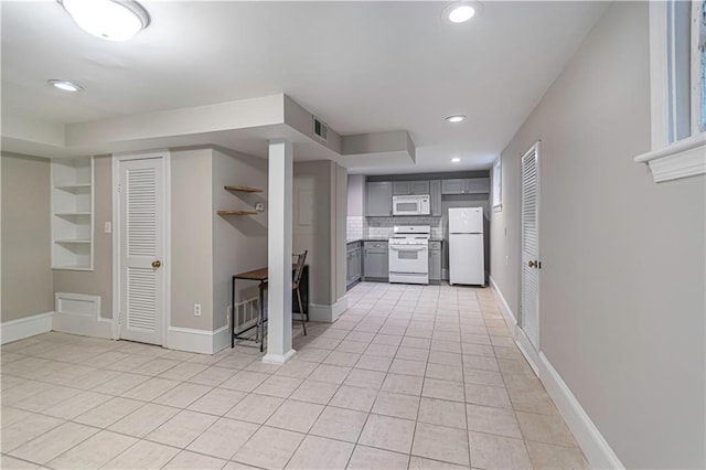 1171 Goodwin Rd NE, Atlanta, GA 30324 - kitchen with white appliances, gray cabinetry, light tile patterned floors, recessed lighting, and built in features