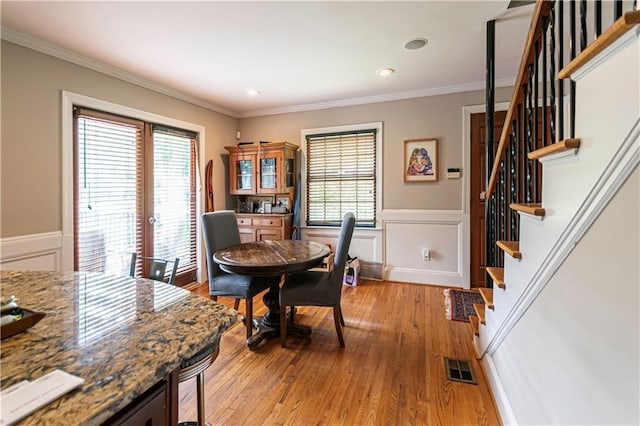 1171 Goodwin Rd NE, Atlanta, GA 30324 - dining space with stairway, healthy amount of natural light, crown molding, light wood finished floors, and wainscoting