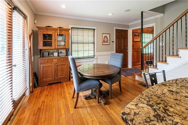 1171 Goodwin Rd NE, Atlanta, GA 30324 - dining area with wainscoting, healthy amount of natural light, light wood finished floors, ornamental molding, and stairway