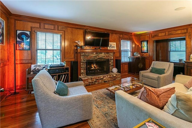 1171 Goodwin Rd NE, Atlanta, GA 30324 - living room with wooden walls, a fireplace, dark wood-style floors, and crown molding