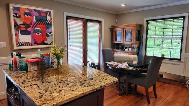 1171 Goodwin Rd NE, Atlanta, GA 30324 - dining room featuring wood finished floors, crown molding, recessed lighting, and wainscoting