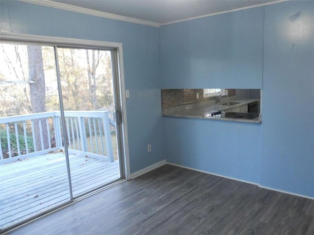 interior space with dark hardwood / wood-style floors, crown molding, and sink