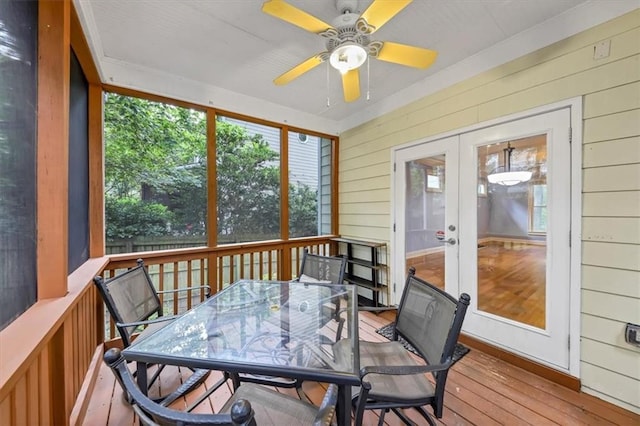 sunroom / solarium featuring french doors and ceiling fan