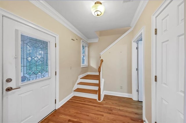 entrance foyer with crown molding and hardwood / wood-style floors