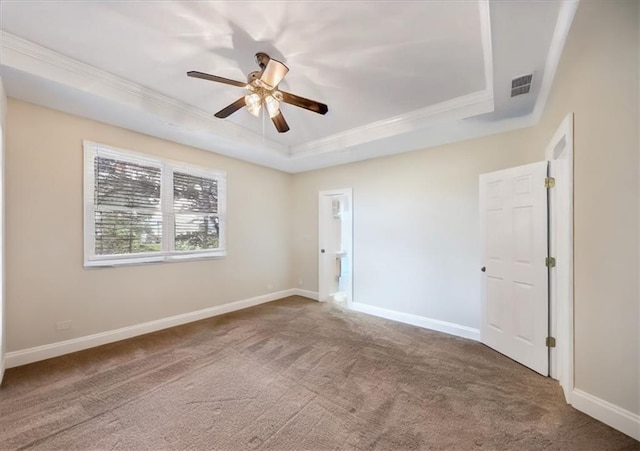 spare room with ceiling fan, crown molding, carpet, and a tray ceiling