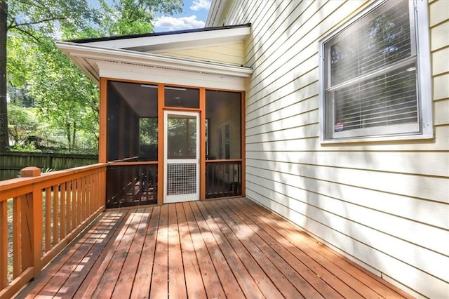 wooden deck with a sunroom