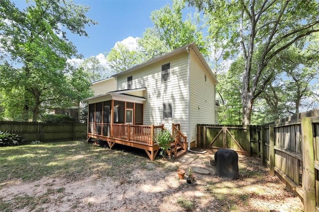 rear view of house featuring a sunroom