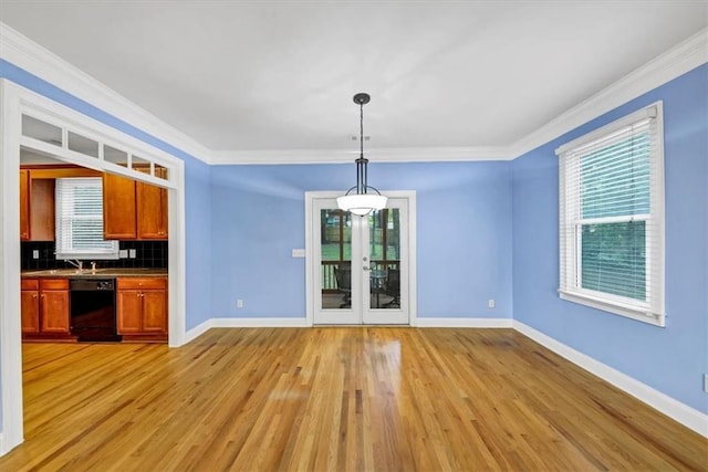 unfurnished dining area with ornamental molding and light hardwood / wood-style floors