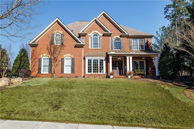 view of front facade with a front lawn and covered porch