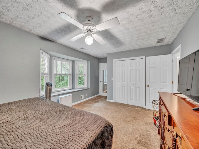 555 Creekwood Xing, Roswell, GA 30076 - bedroom with visible vents, a closet, ceiling fan, a textured ceiling, and carpet flooring