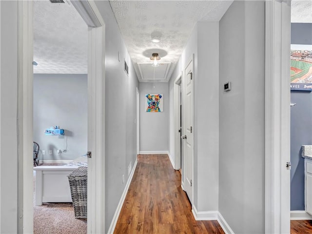 555 Creekwood Xing, Roswell, GA 30076 - corridor featuring visible vents, wood finished floors, baseboards, attic access, and a textured ceiling