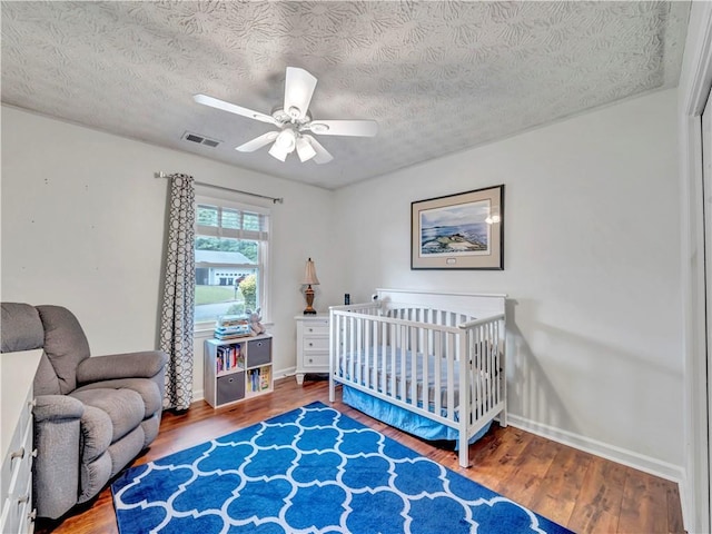 555 Creekwood Xing, Roswell, GA 30076 - bedroom with a textured ceiling, wood finished floors, and visible vents