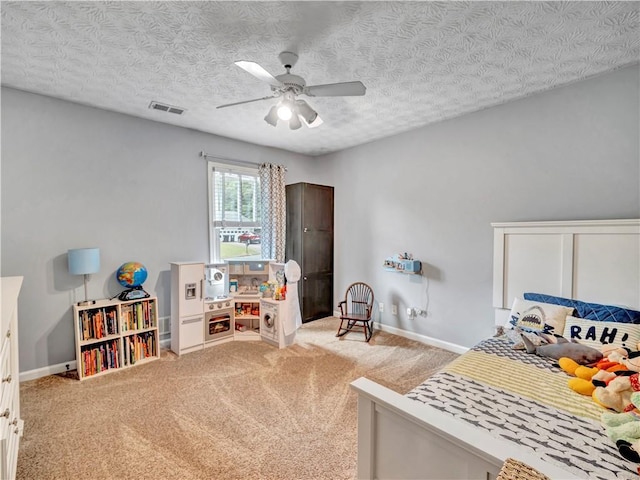 555 Creekwood Xing, Roswell, GA 30076 - carpeted bedroom with visible vents, a textured ceiling, baseboards, and a ceiling fan