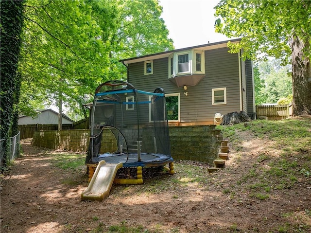 555 Creekwood Xing, Roswell, GA 30076 - back of house featuring a fenced backyard and a trampoline