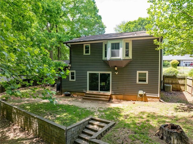 555 Creekwood Xing, Roswell, GA 30076 - back of house featuring a fenced backyard, a fire pit, and entry steps