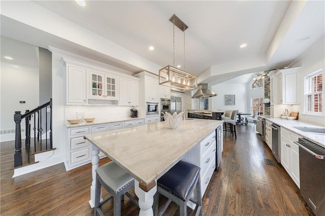 kitchen with white cabinets, dark wood finished floors, and appliances with stainless steel finishes