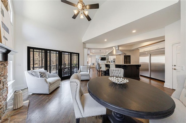 dining room featuring dark wood-style floors, baseboards, recessed lighting, ceiling fan, and high vaulted ceiling