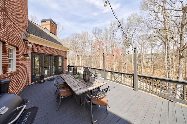 wooden deck featuring outdoor dining space