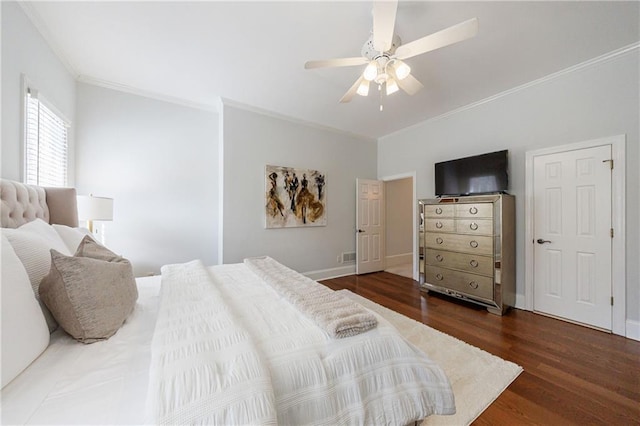 bedroom featuring wood finished floors, ceiling fan, crown molding, and baseboards