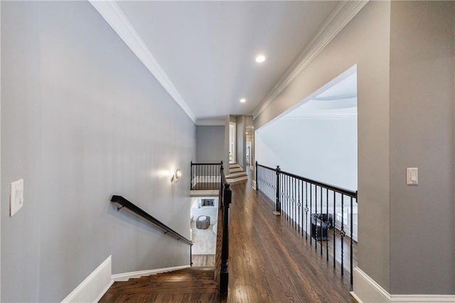 stairs with crown molding, recessed lighting, wood finished floors, and baseboards