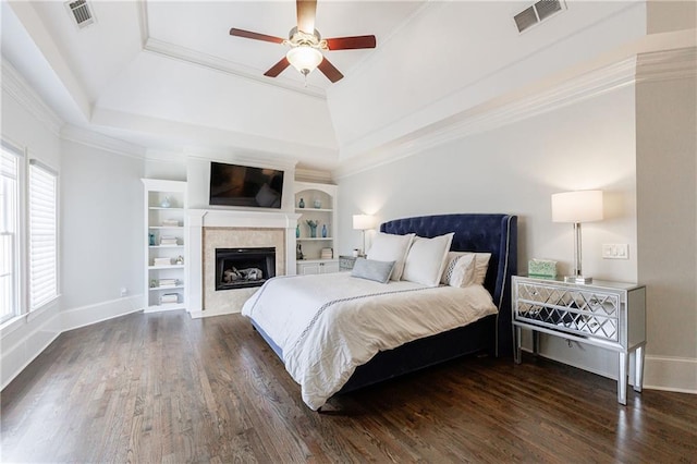 bedroom featuring a raised ceiling, visible vents, and dark wood-style floors
