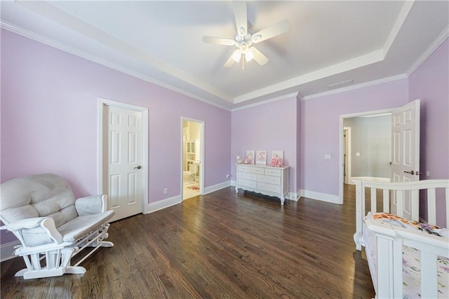bedroom featuring visible vents, a raised ceiling, wood finished floors, and crown molding