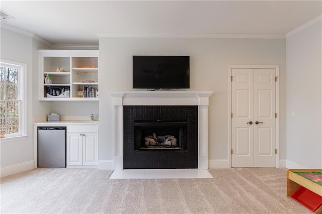 living area with baseboards, ornamental molding, a fireplace with flush hearth, and light colored carpet