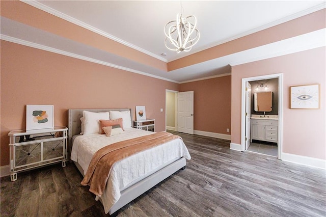 bedroom featuring baseboards, crown molding, wood finished floors, and a chandelier