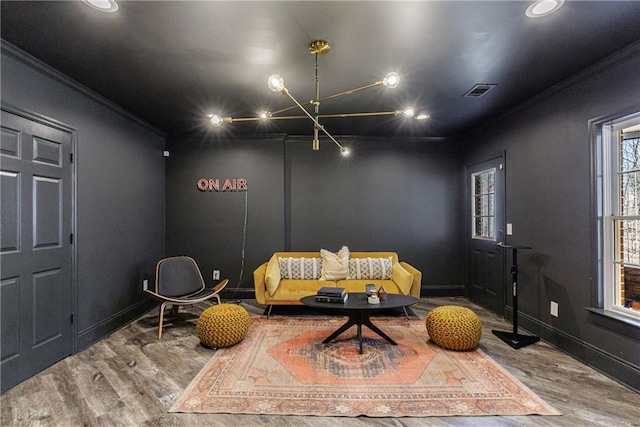 sitting room with recessed lighting, wood finished floors, baseboards, visible vents, and crown molding