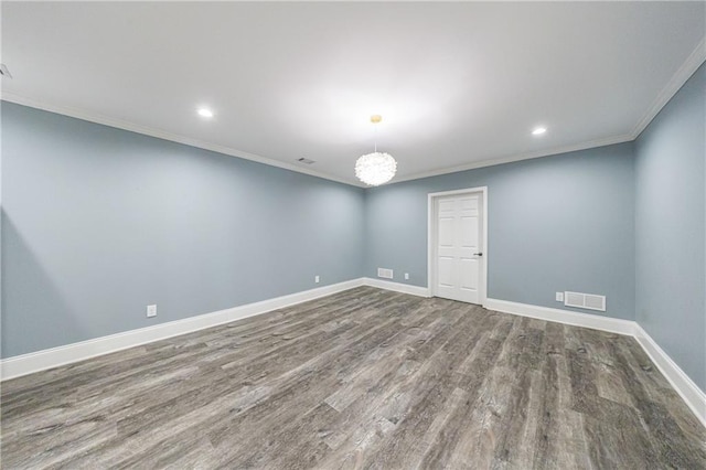 spare room featuring crown molding, visible vents, baseboards, recessed lighting, and wood finished floors