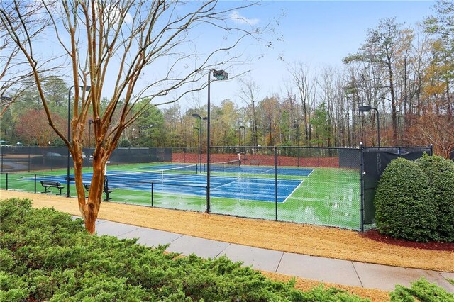 view of tennis court featuring fence