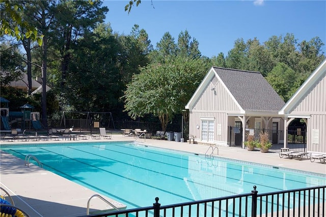 community pool with fence and a patio