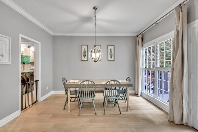 1253 Rivermark Ct, Lawrenceville, GA 30043 - dining space with ornamental molding, light wood finished floors, and baseboards