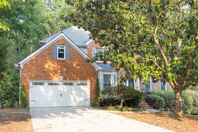 1253 Rivermark Ct, Lawrenceville, GA 30043 - view of front of home with brick siding, concrete driveway, a garage, and roof with shingles