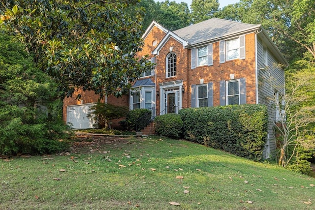 1253 Rivermark Ct, Lawrenceville, GA 30043 - colonial home with a front yard, a garage, and brick siding