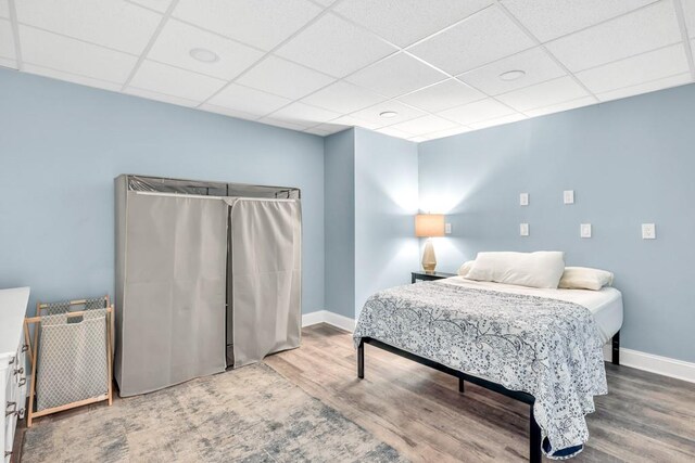 1253 Rivermark Ct, Lawrenceville, GA 30043 - bedroom with wood finished floors, a paneled ceiling, and baseboards