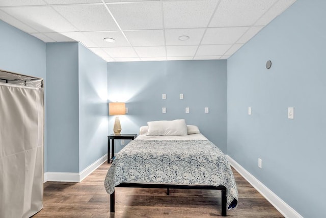 1253 Rivermark Ct, Lawrenceville, GA 30043 - bedroom with wood finished floors, baseboards, and a drop ceiling