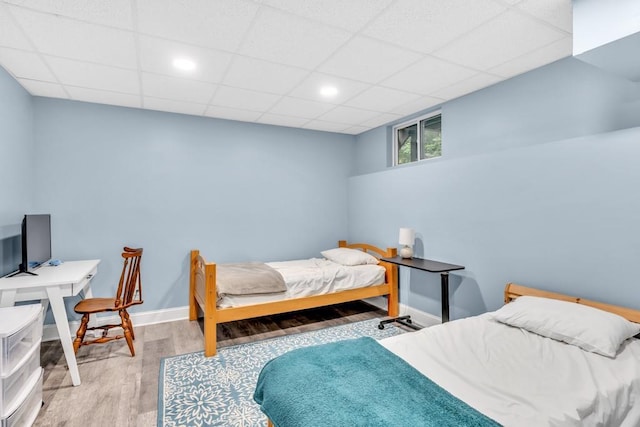 1253 Rivermark Ct, Lawrenceville, GA 30043 - bedroom with wood finished floors, baseboards, and a paneled ceiling