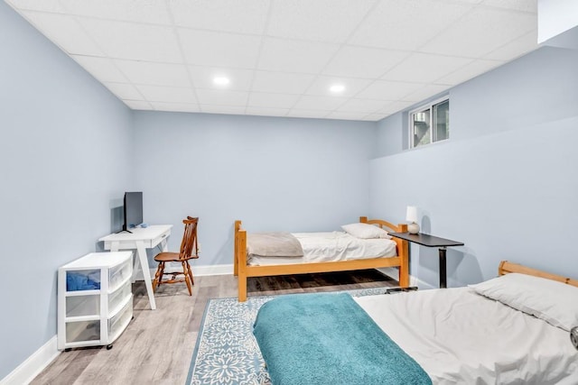 1253 Rivermark Ct, Lawrenceville, GA 30043 - bedroom with wood finished floors, baseboards, a paneled ceiling, and recessed lighting