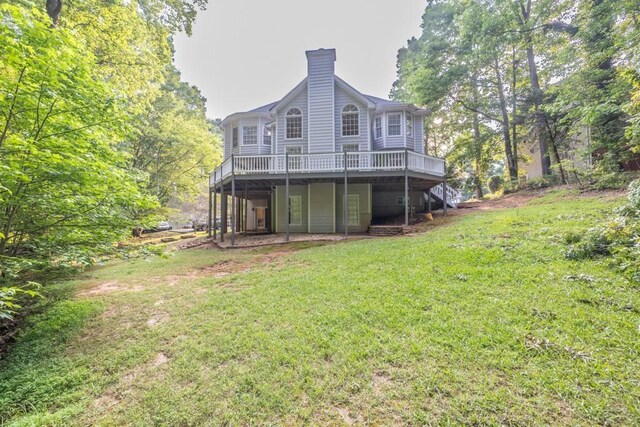 1253 Rivermark Ct, Lawrenceville, GA 30043 - rear view of house featuring a deck, a yard, a chimney, and stairway