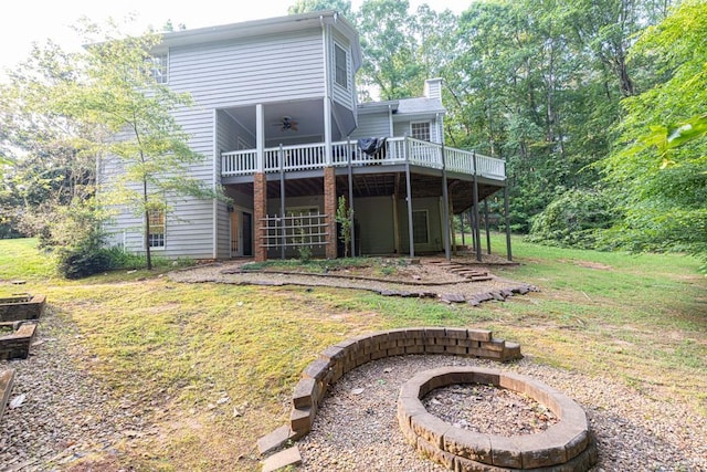 1253 Rivermark Ct, Lawrenceville, GA 30043 - back of property featuring a wooden deck, a chimney, a ceiling fan, an outdoor fire pit, and a yard