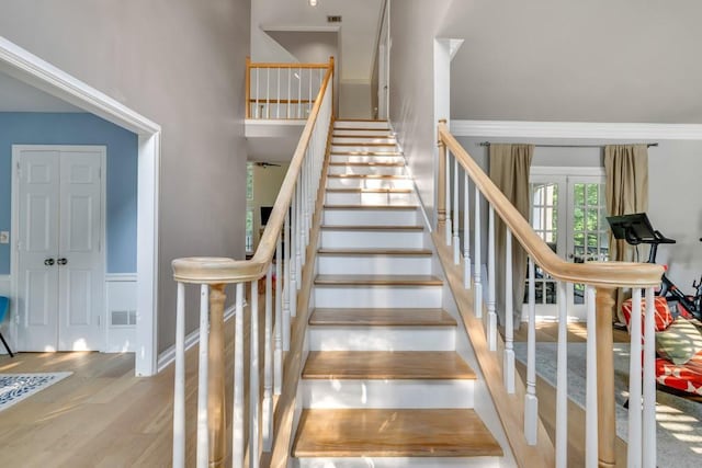 1253 Rivermark Ct, Lawrenceville, GA 30043 - staircase with wood finished floors, baseboards, and crown molding