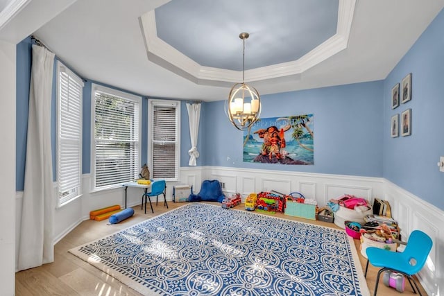 1253 Rivermark Ct, Lawrenceville, GA 30043 - recreation room featuring a chandelier, a raised ceiling, a wainscoted wall, and a decorative wall